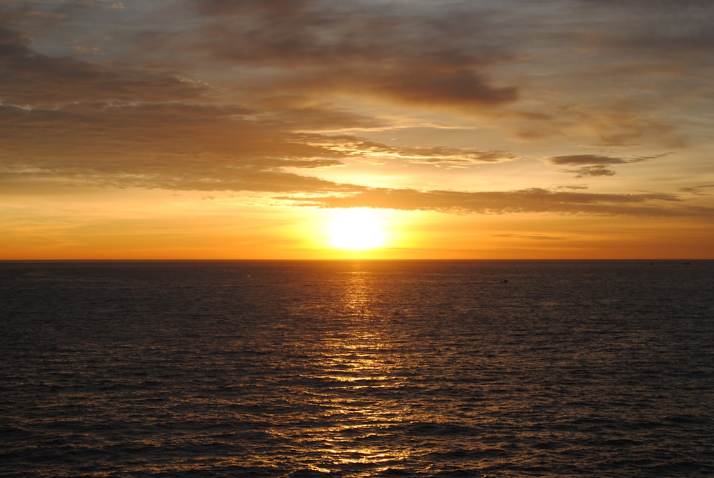 body of water during sunset