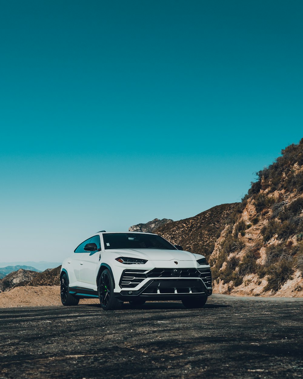 white car on brown dirt road during daytime