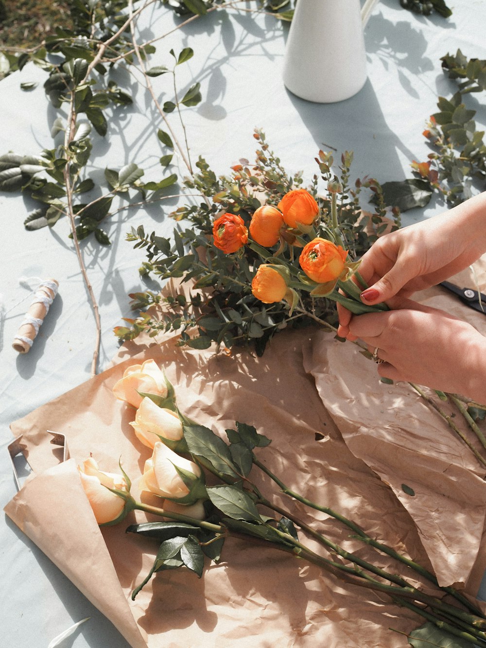 person holding orange fruit near green leaves