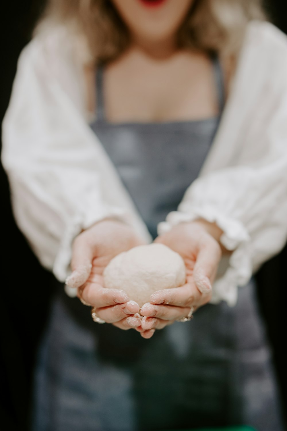 woman in white dress holding white textile