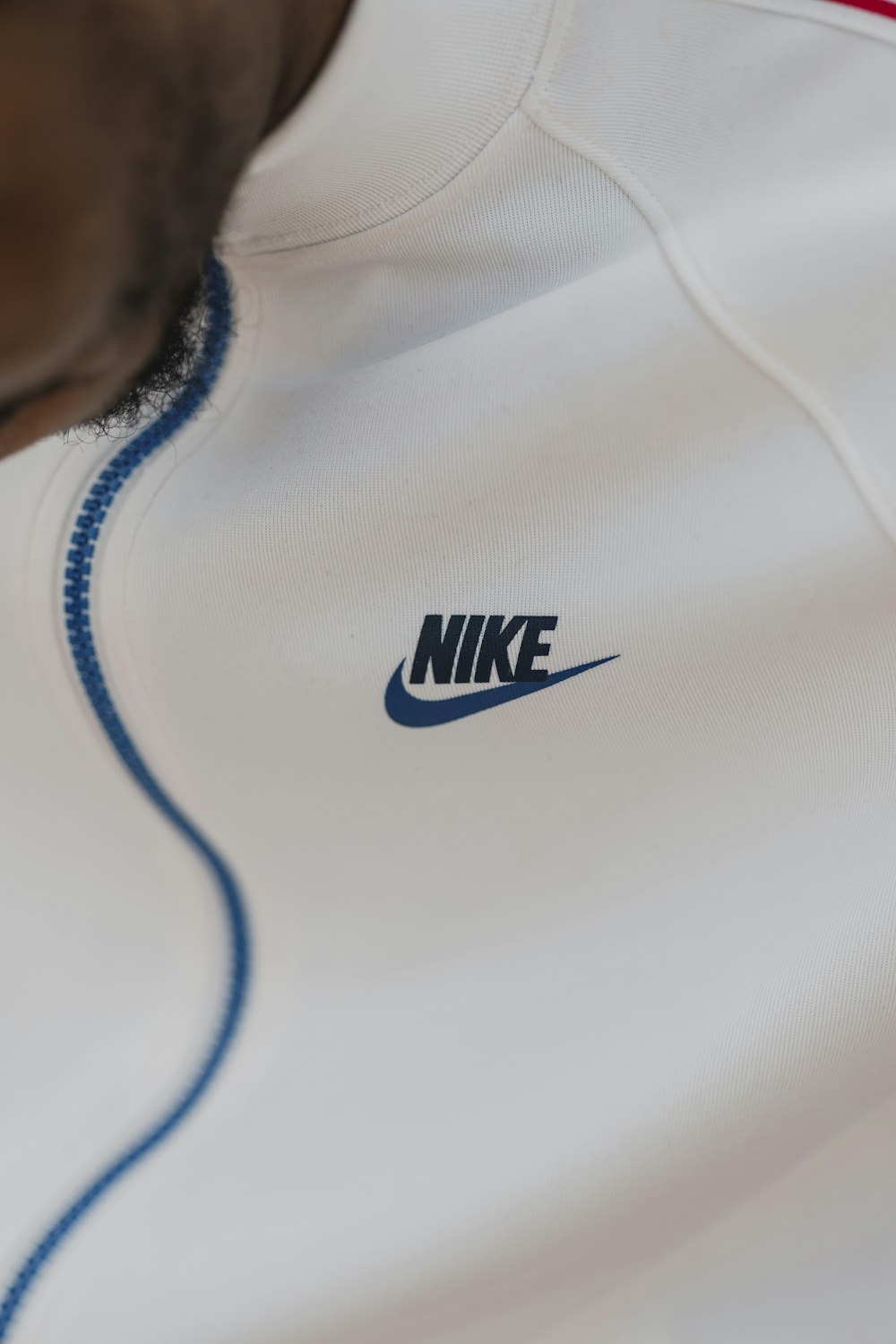 person in white nike crew neck shirt
