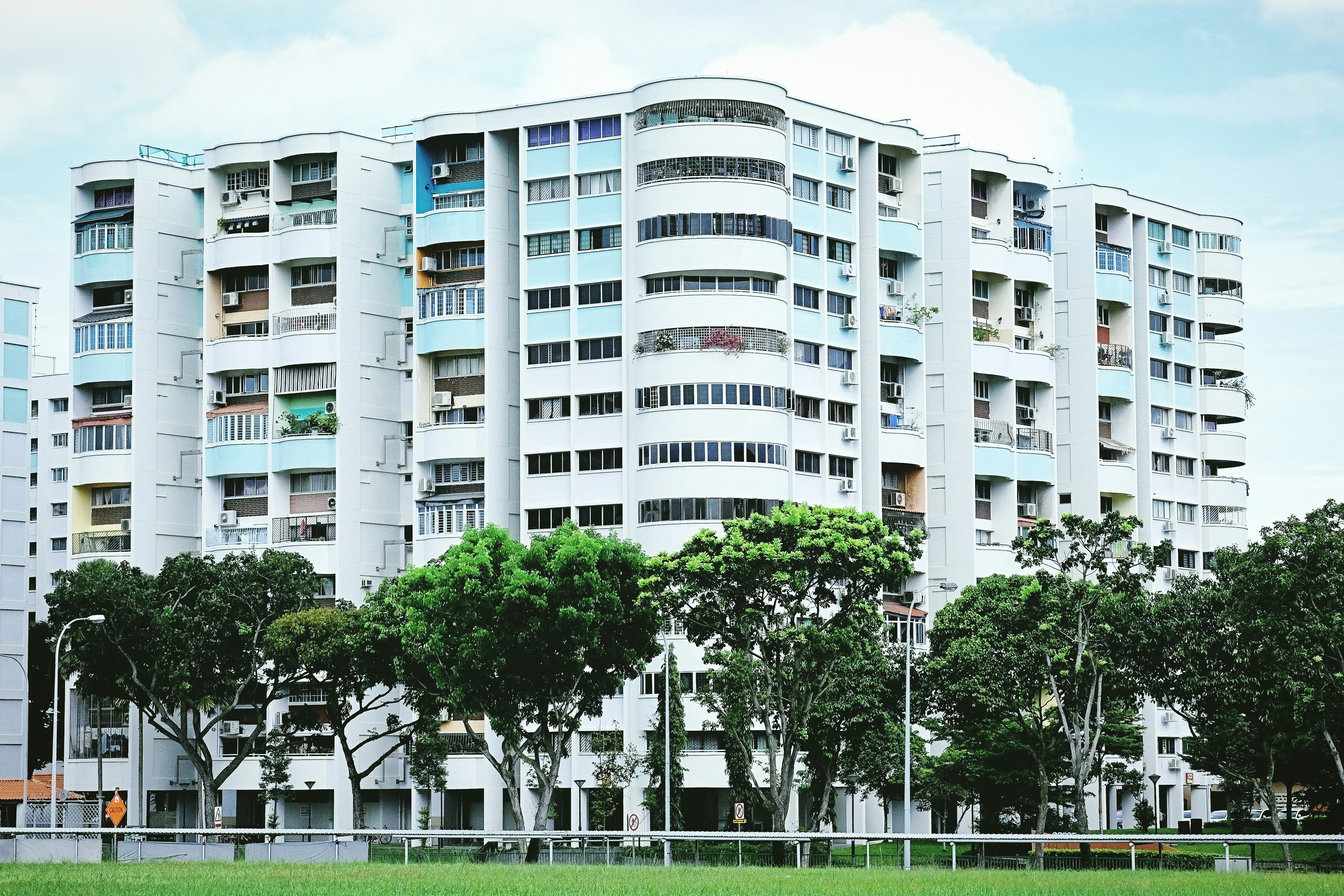 white concrete building near green trees during daytime