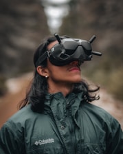 A remote explorer wearing a VR headset, immersed in a live walk through a forest trail.