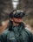 A woman with VR headset smiling, immersed in a virtual walk through a forest trail.