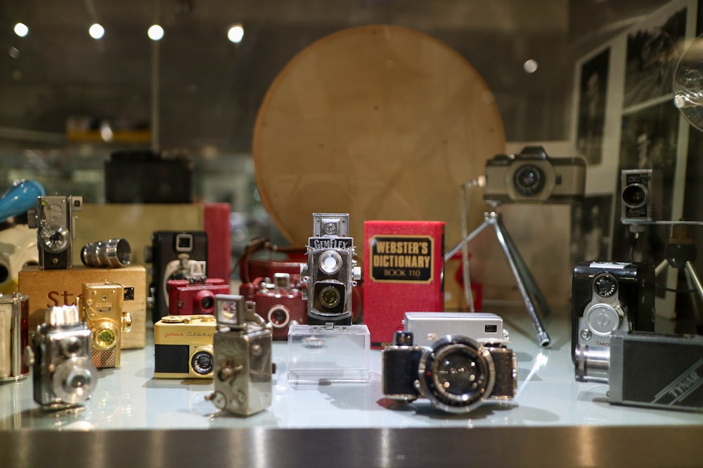 red and silver camera on glass shelf