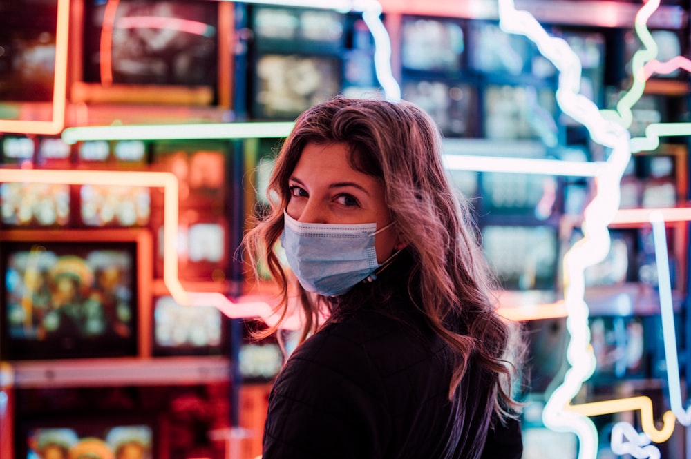 woman in black jacket with white face mask