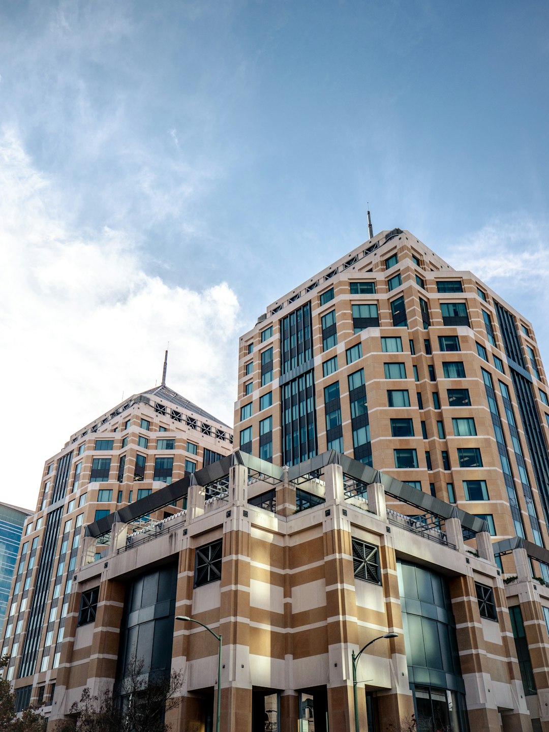 brown concrete building under white clouds during daytime