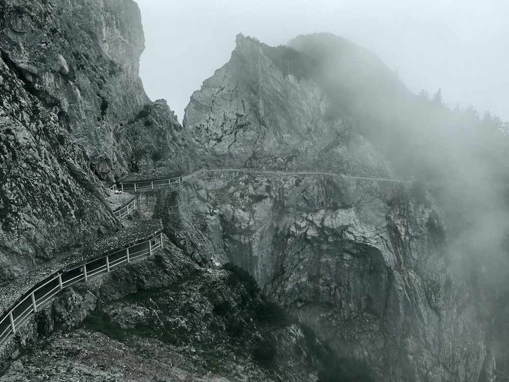 gray wooden bridge on mountain