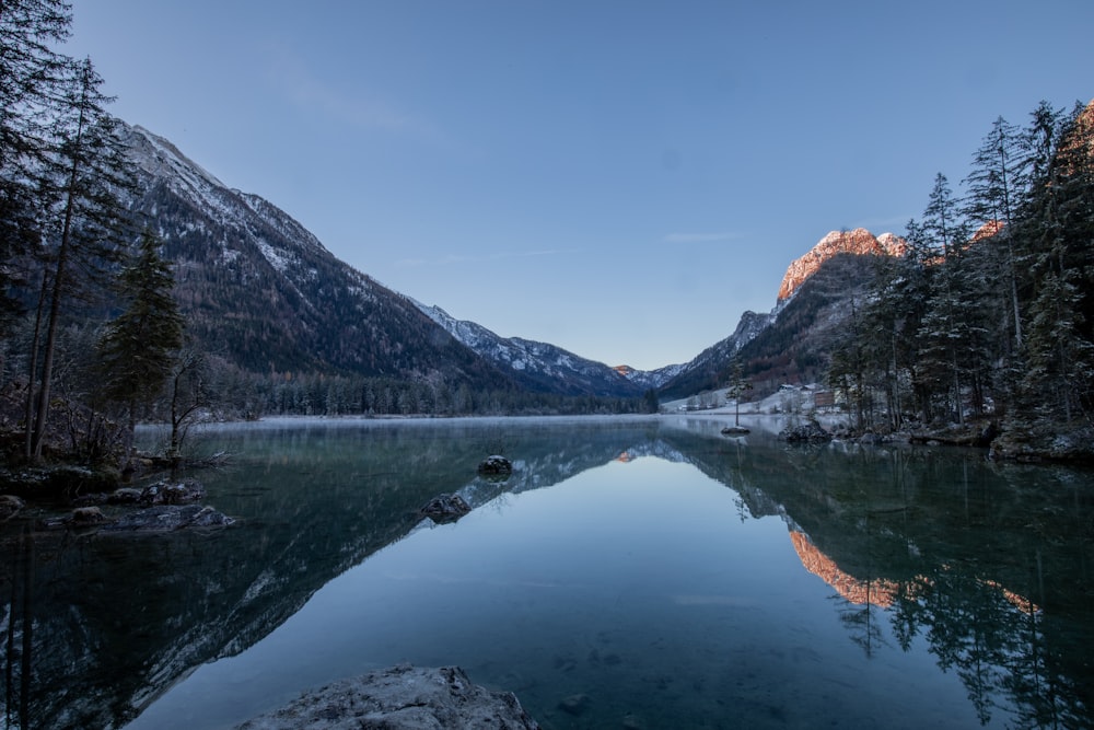 lake in the middle of mountains during daytime