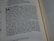 A close-up view of a Bible passage, focusing on a section of text with chapter and verse numbers visible. The text is formatted in two columns on a cream-colored page with thin black lines separating sections.