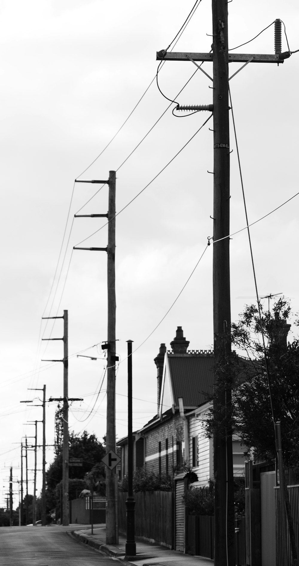 grayscale photo of electric post