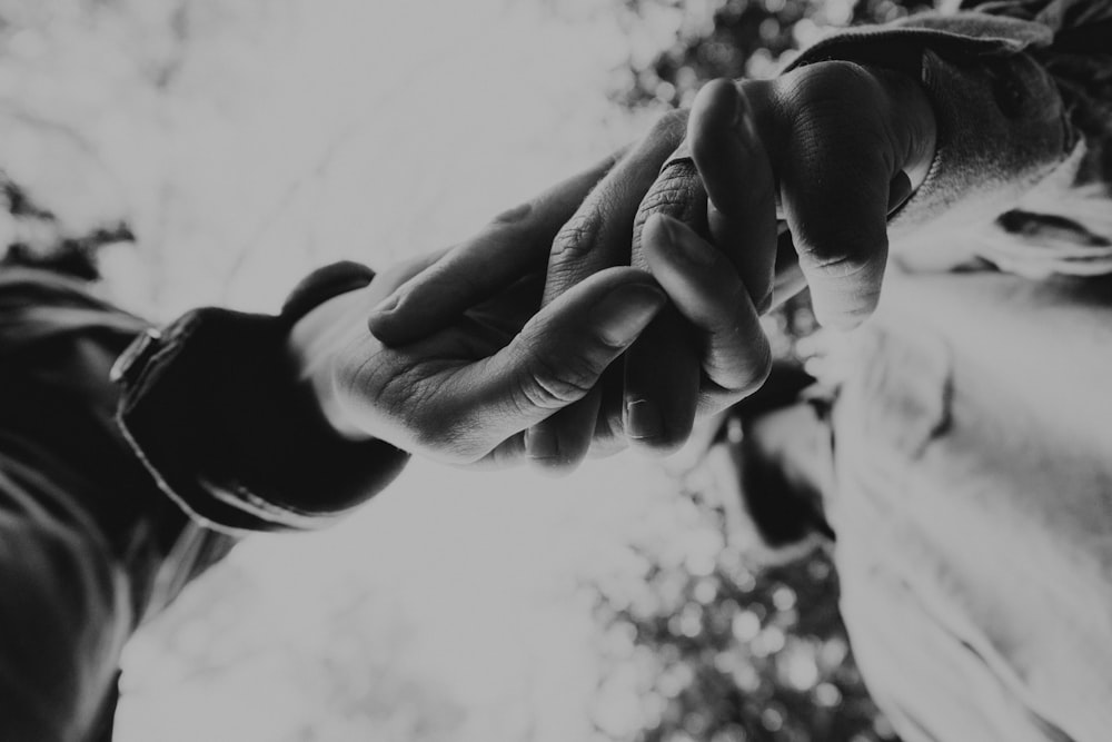 grayscale photo of persons hand