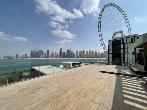 Spacious penthouse terrace overlooking the city skyline on a clear day.