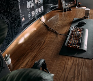 black computer keyboard on brown wooden table