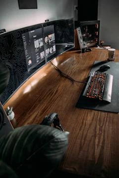 A vibrant workspace showing a custom-built PC surrounded by influencer gear and branding materials.