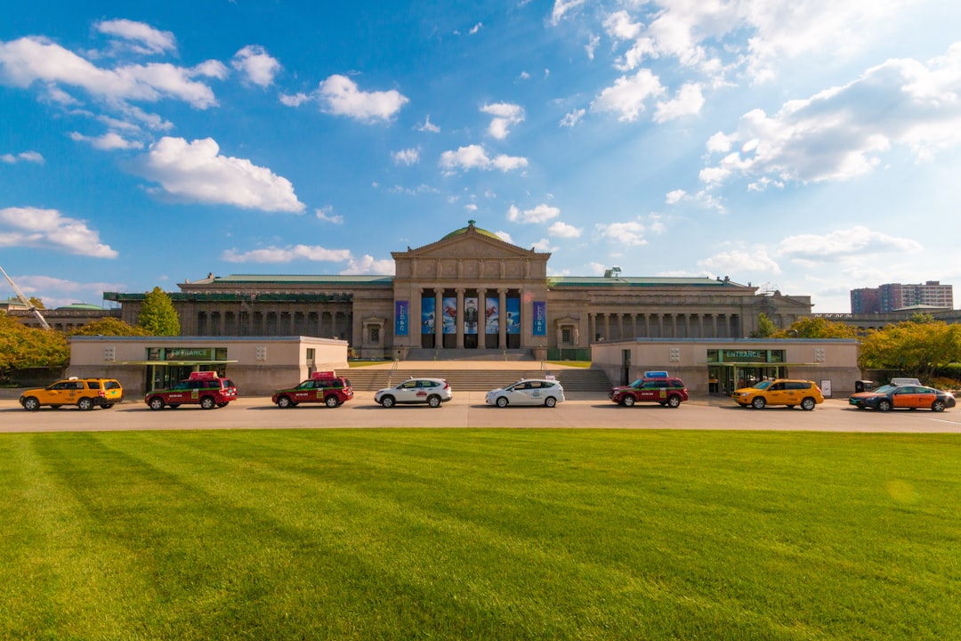 cars parked in front of brown building,