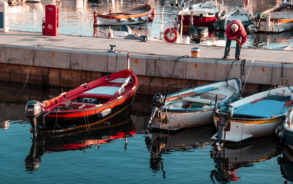 red and white boat on dock during daytime