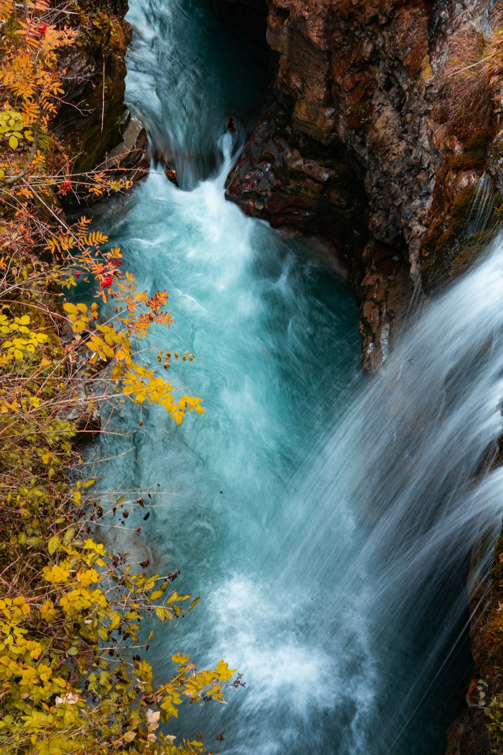 water falls in brown rocky mountain