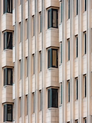 white concrete building with glass windows