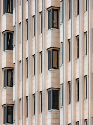 white concrete building with glass windows
