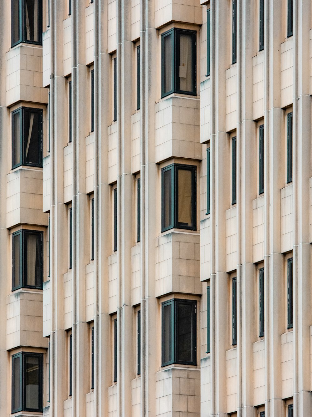 white concrete building with glass windows