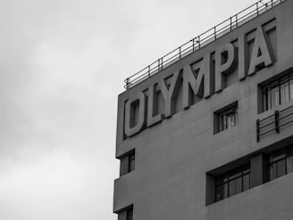a black and white photo of a building with a sign on it