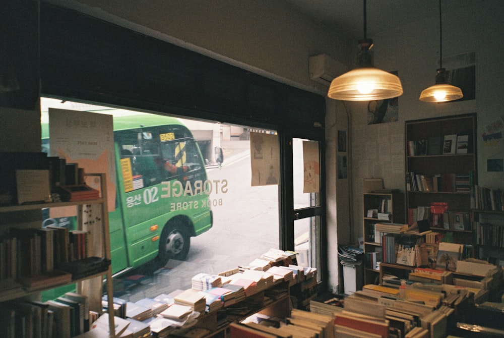 green and black bus in front of brown wooden boxes