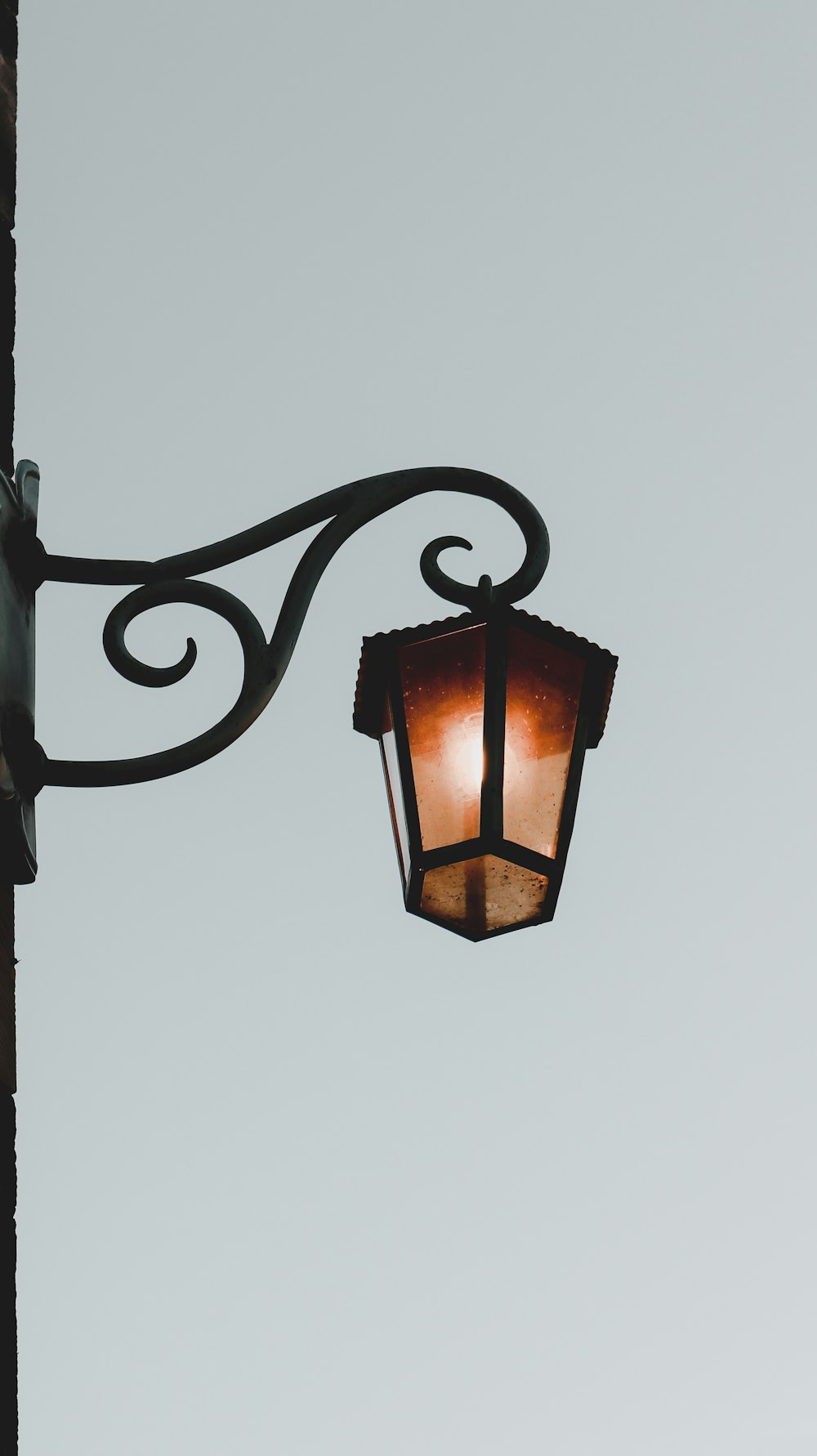 black metal frame lamp turned on during daytime