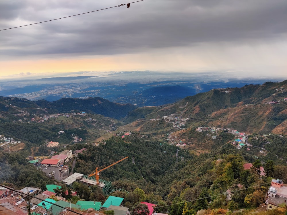 cable cars over green mountains during daytime