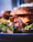 Close-up of a juicy smash burger with caramelized grilled onions and fresh lettuce on a toasted bun.