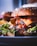 A close-up of a juicy burger with fresh toppings on a wooden table.