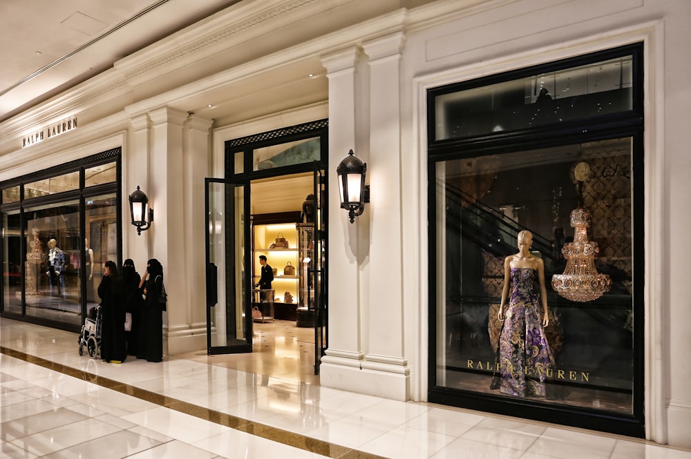 woman in black and white dress standing near door