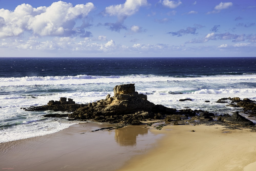 brown rock formation on sea shore during daytime