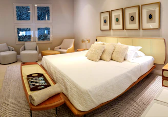 white bed linen with throw pillows