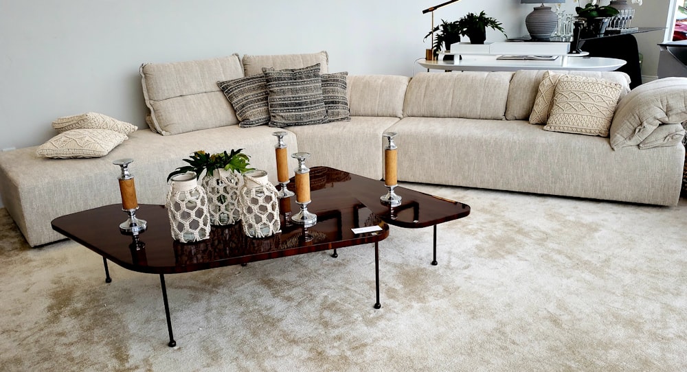 brown wooden coffee table near white sofa