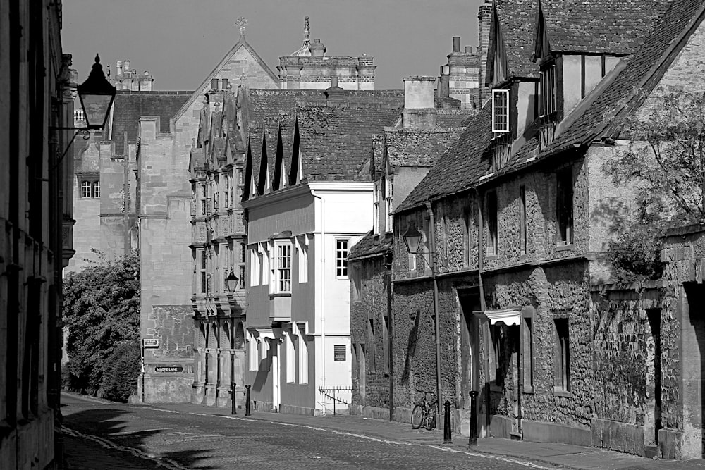 grayscale photo of houses near road