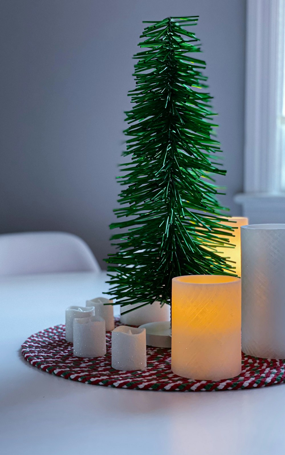 three orange pillar candles on white ceramic sink