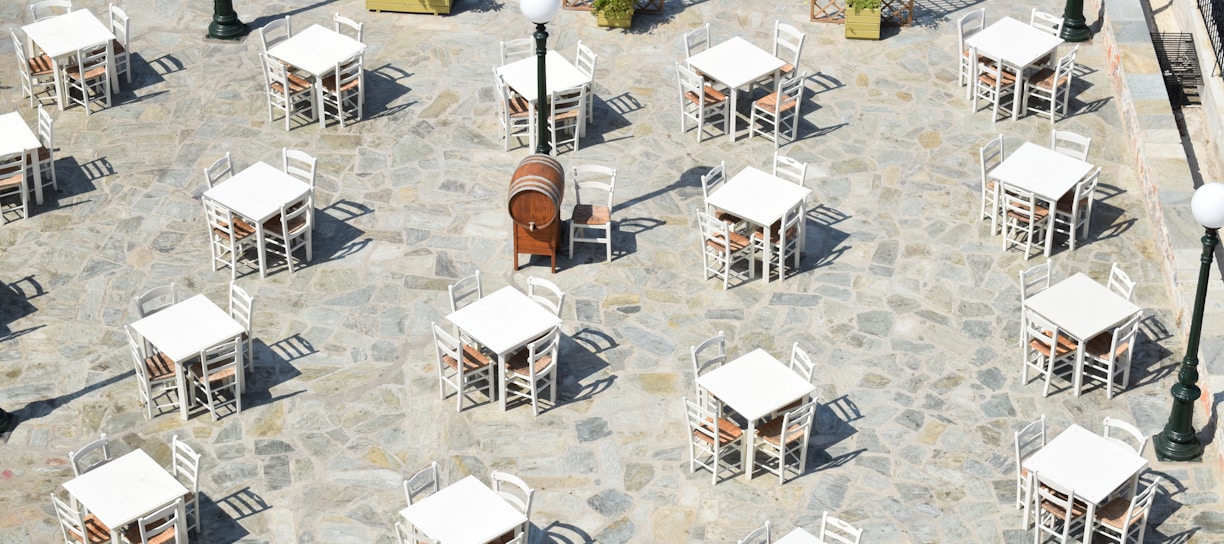 white and brown wooden chairs and tables