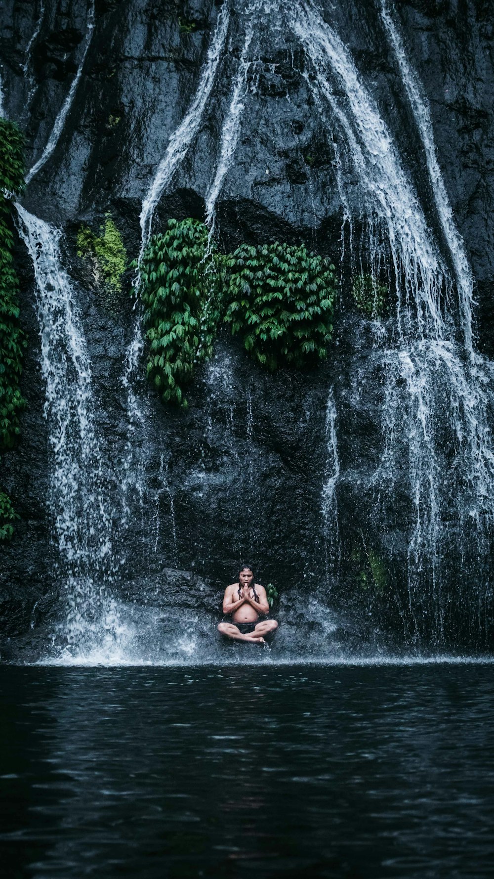 woman in black bikini sitting on water fountain