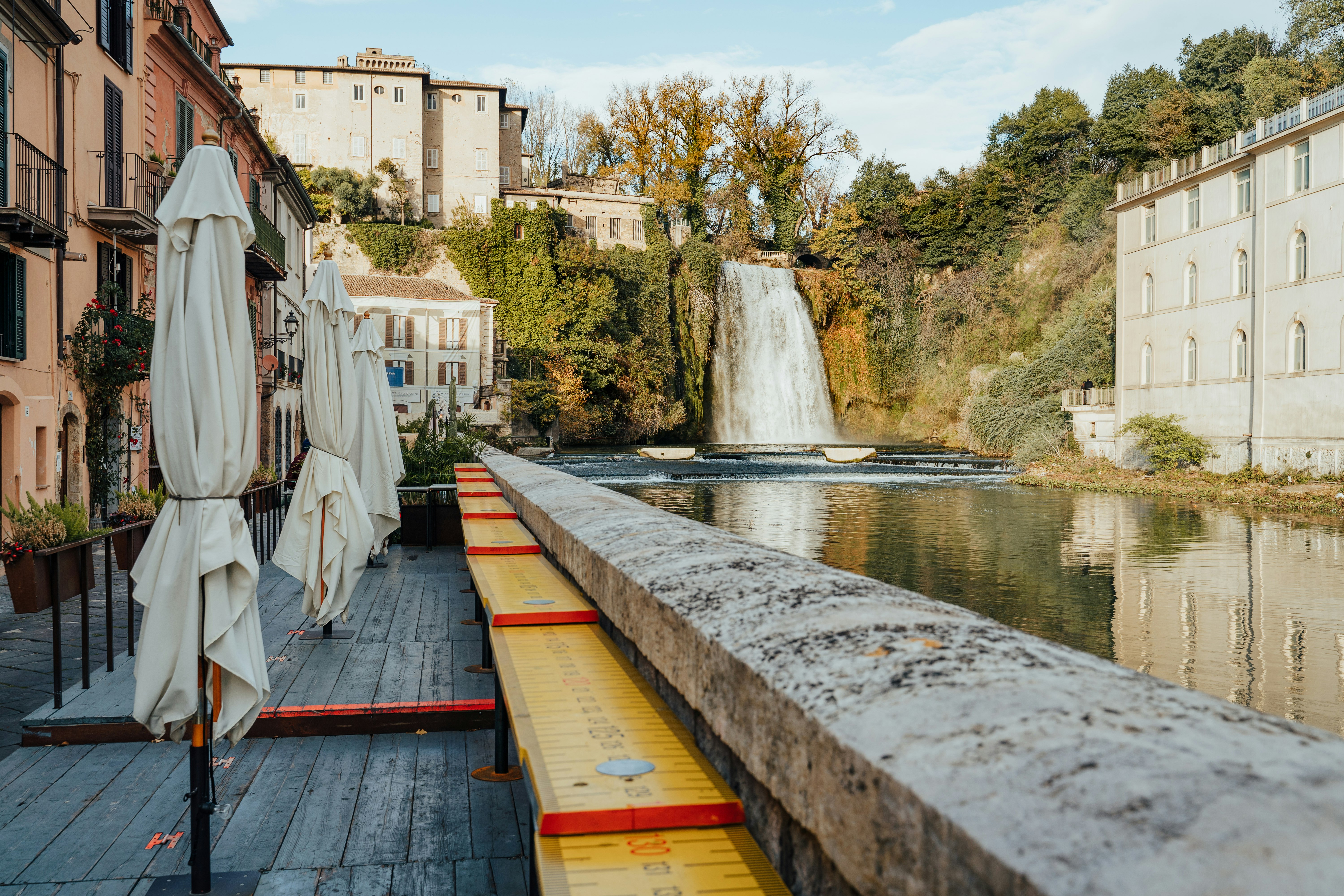 white and brown concrete building beside river during daytime