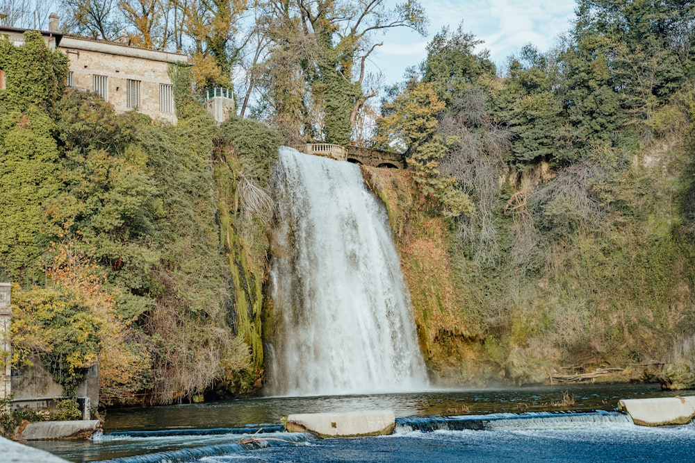 white and brown house near waterfalls during daytime