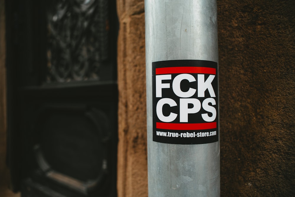 a sticker on a pole on the side of a building