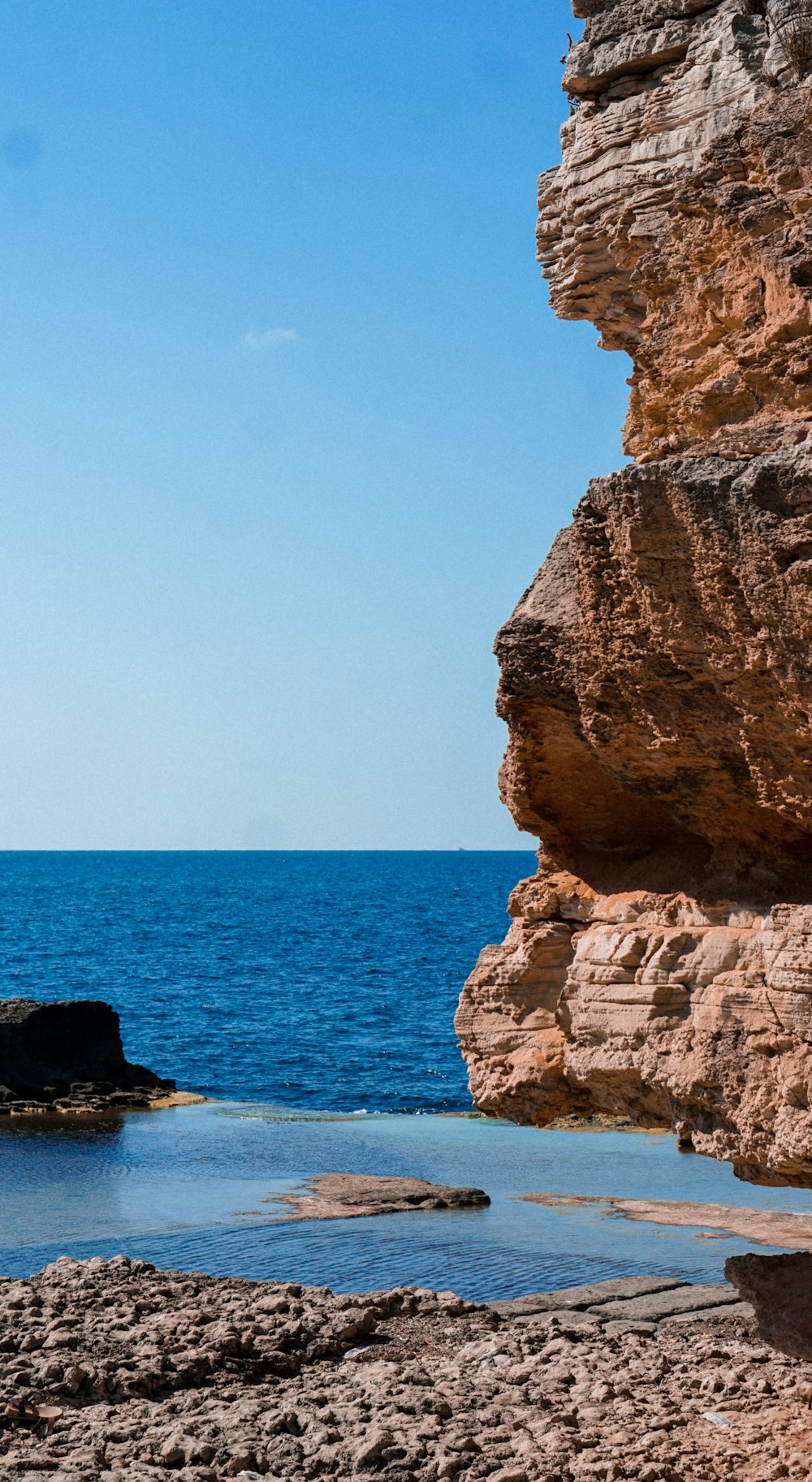 brown rock formation on sea during daytime