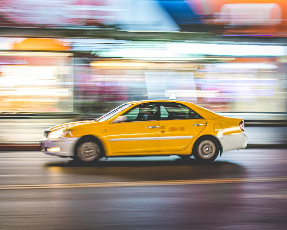 yellow taxi cab on road