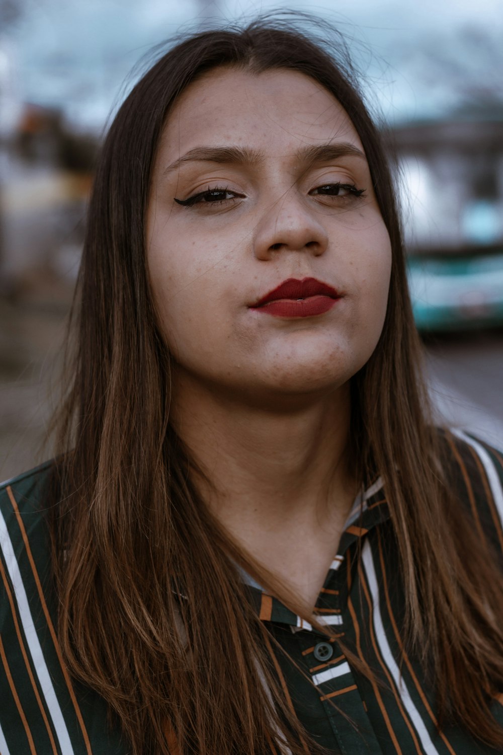 woman in white and black striped shirt with red lipstick