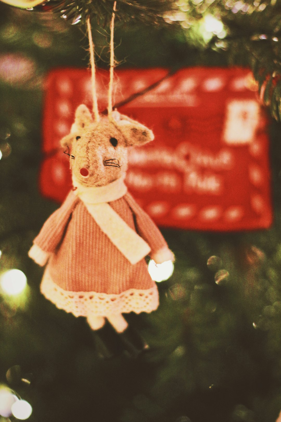 brown bear plush toy hanging on christmas tree