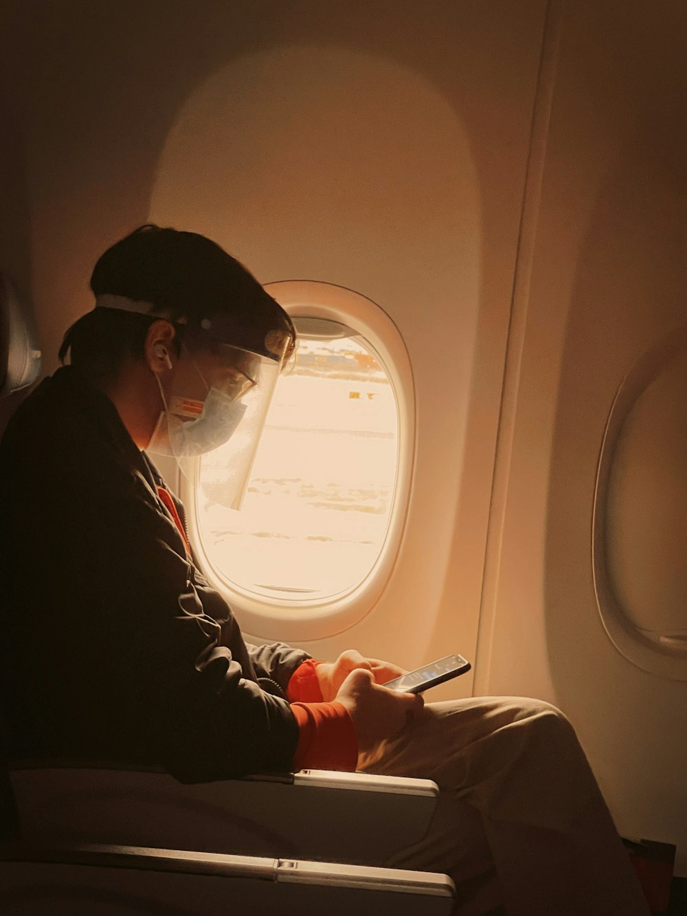 woman in black jacket holding smartphone