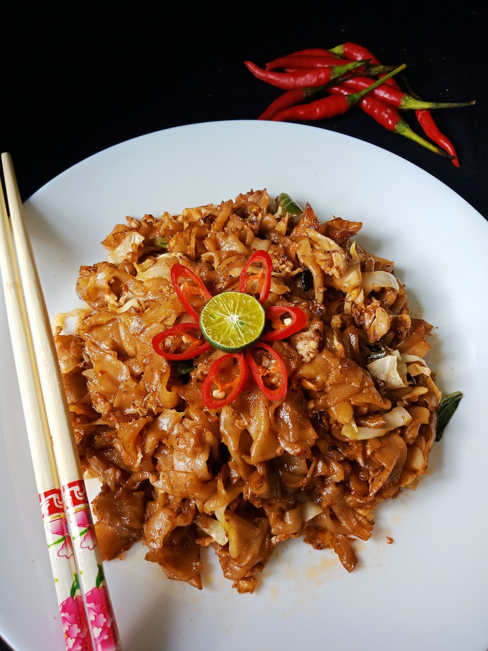 a plate of food with chopsticks next to it