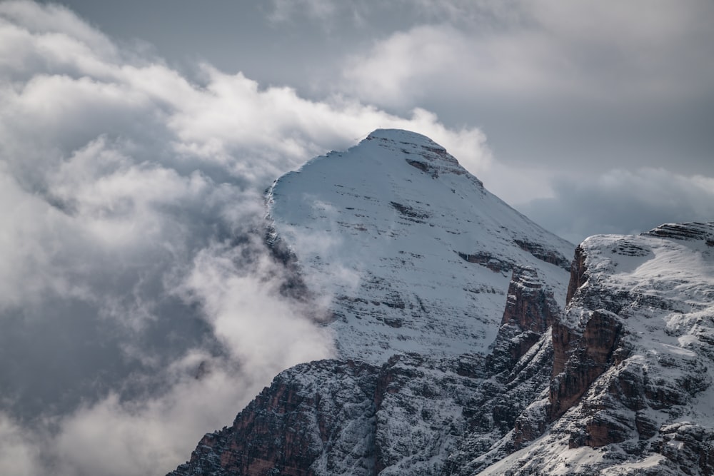 white clouds over snow covered mountain