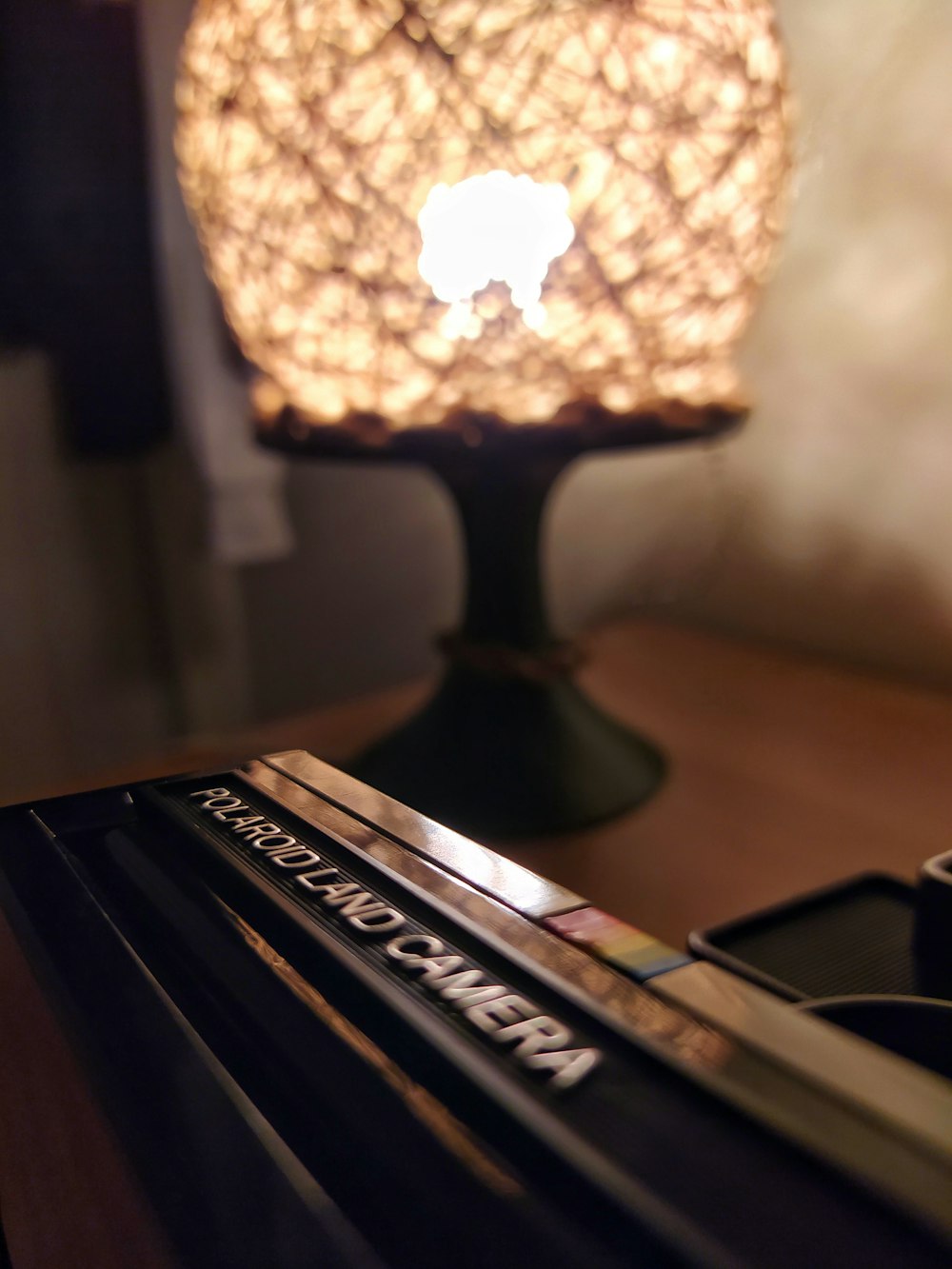 black and brown table lamp turned on on brown wooden table